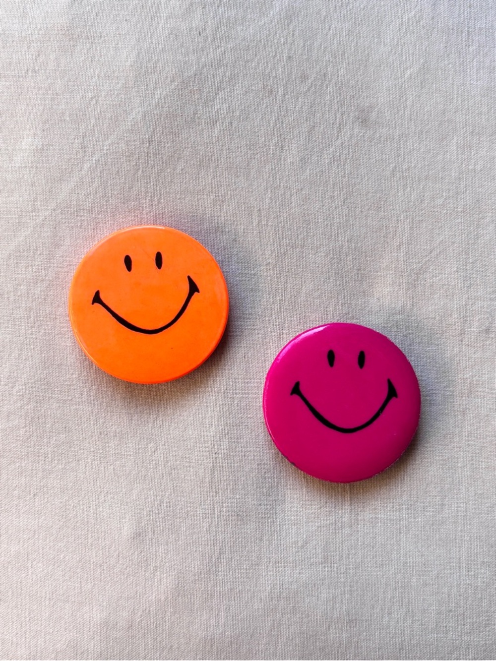 1990s neon orange and dark magenta pink smiley face button pins